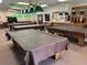 The game room features multiple pool tables, perfect for leisurely entertainment and friendly competition at 5402 Rosewall Cir, Leesburg, FL 34748