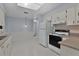 Spacious kitchen with bright white cabinets, tile flooring, and modern appliances at 5402 Rosewall Cir, Leesburg, FL 34748