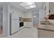 Well-lit kitchen with tile floors, white appliances, and ample cabinet space at 5402 Rosewall Cir, Leesburg, FL 34748