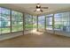 Enclosed lanai with wall-to-wall windows that provide serene views of the surrounding landscape at 5402 Rosewall Cir, Leesburg, FL 34748