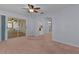 Living room boasts natural light, carpet, blue walls, and open access to other rooms at 5402 Rosewall Cir, Leesburg, FL 34748