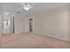 A light-filled main bedroom with neutral walls, carpet, and views to the en-suite at 5402 Rosewall Cir, Leesburg, FL 34748