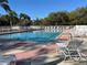 Inviting outdoor pool surrounded by mature trees and comfortable lounge chairs at 5402 Rosewall Cir, Leesburg, FL 34748