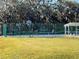Outdoor pickleball courts with green fencing surrounded by mature landscaping at 5402 Rosewall Cir, Leesburg, FL 34748