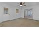 Bright sunroom featuring white walls, concrete floor, and ceiling fan at 5402 Rosewall Cir, Leesburg, FL 34748
