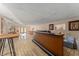 Spacious finished basement area with tile flooring, a wet bar, and access to the exterior at 601 N Mcdonald St # 208, Mount Dora, FL 32757