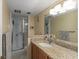 Bathroom featuring a shower and granite vanity at 601 N Mcdonald St # 208, Mount Dora, FL 32757
