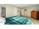 Cozy bedroom featuring a comfortable bed and wood dresser at 601 N Mcdonald St # 208, Mount Dora, FL 32757