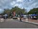 Local farmers market with vendors selling fresh produce and goods in a lively community setting at 601 N Mcdonald St # 208, Mount Dora, FL 32757