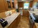 Charming kitchen featuring stone countertops, wood cabinetry, and stainless steel appliances at 601 N Mcdonald St # 208, Mount Dora, FL 32757