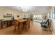 Open-concept living and dining area with natural light and access to balcony at 601 N Mcdonald St # 208, Mount Dora, FL 32757