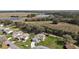 Aerial view of a lovely single-story home with a long driveway, lush green lawn, and beautiful lake views at 6022 Wilander St, Leesburg, FL 34748