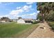 Spacious backyard featuring a screened lanai and lush green lawn at 6022 Wilander St, Leesburg, FL 34748