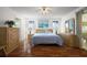 Bright bedroom with wood floors, ceiling fan, and sliding doors to the lanai at 6022 Wilander St, Leesburg, FL 34748