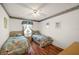 Bedroom with laminate floors, ceiling fan, large window, and two twin beds at 6022 Wilander St, Leesburg, FL 34748