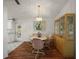 Bright dining room and dining table features laminate floors and an elegant chandelier at 6022 Wilander St, Leesburg, FL 34748