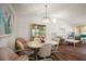 Cozy dining area with hardwood floors and a stylish chandelier, adjacent to the living room at 6022 Wilander St, Leesburg, FL 34748