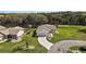 Well-manicured lawn, landscape beds, and a curved driveway accentuate this charming single-story home at 6022 Wilander St, Leesburg, FL 34748
