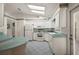 Bright kitchen featuring a breakfast bar, white cabinets, and neutral countertops at 6022 Wilander St, Leesburg, FL 34748
