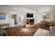 Open-concept living room and dining area with laminate floors and bright lighting at 6022 Wilander St, Leesburg, FL 34748