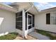 Exterior view of a screened-in porch with access to the home's entrance at 6022 Wilander St, Leesburg, FL 34748