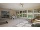 Bright sunroom with tile flooring, ceiling fans, and views of the landscaped backyard at 6022 Wilander St, Leesburg, FL 34748