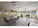 Bright sunroom with tile flooring, ceiling fans, and views of the landscaped backyard at 6022 Wilander St, Leesburg, FL 34748