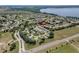 Aerial view of a neighborhood near Little Lake Harris with mature trees and community features at 6122 Sailboat Ave, Tavares, FL 32778