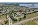 Aerial view of a neighborhood near Little Lake Harris with mature trees and community features at 6122 Sailboat Ave, Tavares, FL 32778