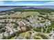 Aerial shot of a neighborhood with mature trees, community features, and a greenbelt at 6122 Sailboat Ave, Tavares, FL 32778