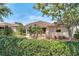 Green backyard featuring a privacy hedge, a screened lanai, and tasteful landscaping at 6122 Sailboat Ave, Tavares, FL 32778