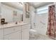 Bright bathroom with a shower/tub combo with a curtain, a toilet, and a sink at 6122 Sailboat Ave, Tavares, FL 32778