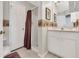 Bathroom featuring a shower with a curtain, a toilet, and a vanity at 6122 Sailboat Ave, Tavares, FL 32778