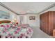 A bedroom with light gray carpet, a ceiling fan, and an armoire in the corner at 6122 Sailboat Ave, Tavares, FL 32778