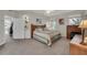 Bright bedroom with large bed, an elegant desk, and a door to a patio at 6122 Sailboat Ave, Tavares, FL 32778