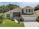 Charming home featuring a well-manicured lawn and inviting front porch at 6122 Sailboat Ave, Tavares, FL 32778