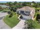 Beautiful two-story home with attached two-car garage and manicured lawn and landscaping at 6122 Sailboat Ave, Tavares, FL 32778