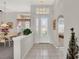 Bright foyer with tile flooring, decorative glass front door, and adjacent dining area at 6122 Sailboat Ave, Tavares, FL 32778