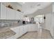 Bright kitchen featuring white cabinets, granite countertops, and ample counter space at 6122 Sailboat Ave, Tavares, FL 32778