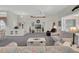 Spacious living room with neutral decor, large windows, and comfortable seating at 6122 Sailboat Ave, Tavares, FL 32778