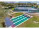 Aerial view of the community shuffleboard and tennis courts in a well maintained lakeside community at 6122 Sailboat Ave, Tavares, FL 32778