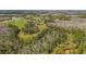 Beautiful aerial shot of the property's verdant land and scattered ponds at 6813 S Fork Ranch Dr, Clermont, FL 34714