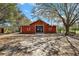 Spacious red barn with ample storage and workspace, ideal for agricultural or hobbyist pursuits at 6813 S Fork Ranch Dr, Clermont, FL 34714