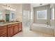 Bathroom featuring a soaking tub, with tile and granite countertops at 6813 S Fork Ranch Dr, Clermont, FL 34714