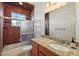 Bathroom with granite countertop vanity, tiled shower, and natural light from the window at 6813 S Fork Ranch Dr, Clermont, FL 34714