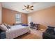 Bedroom with wood floors, a ceiling fan, and a desk at 6813 S Fork Ranch Dr, Clermont, FL 34714