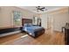 Spacious bedroom with a ceiling fan, a bed with drawers, and two windows providing natural light at 6813 S Fork Ranch Dr, Clermont, FL 34714