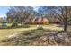 Quaint home with a charming exterior and surrounding trees and green lawn at 6813 S Fork Ranch Dr, Clermont, FL 34714