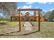 Charming home featuring a rustic wooden archway, lush landscaping, and a welcoming entrance at 6813 S Fork Ranch Dr, Clermont, FL 34714