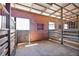 Horse stall interior with wooden paneling and sturdy construction, ready for equine residents at 6813 S Fork Ranch Dr, Clermont, FL 34714